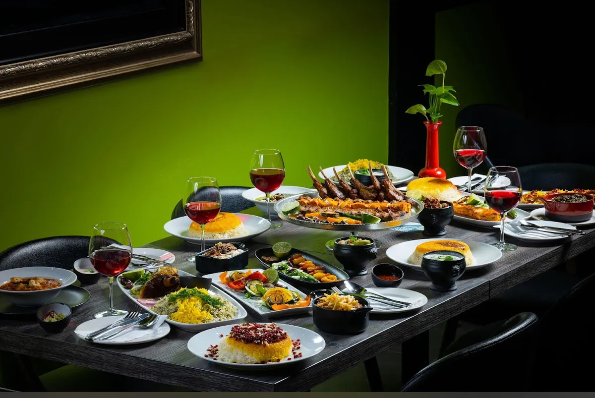 Table laden with various Persian dishes and wine