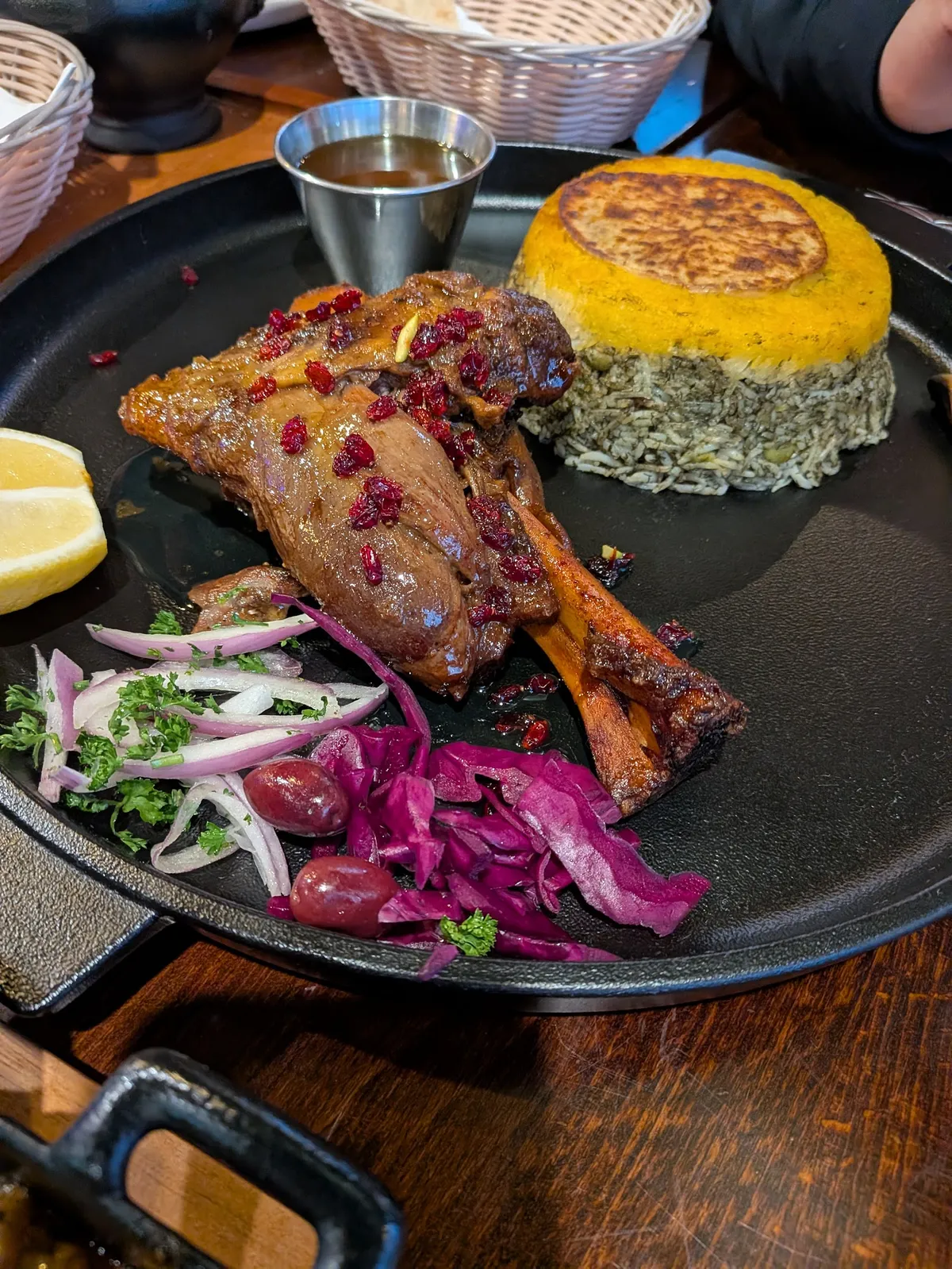 Persian lamb shank with rice, barberries, and vegetables